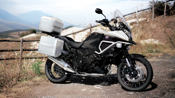 Side on, right-facing silver Honda Crosstourer. Rural location.