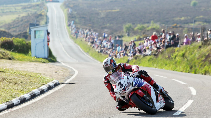 Predný trojštvrťový pohľad zľava na model Honda Fireblade, na trati s jazdcom.