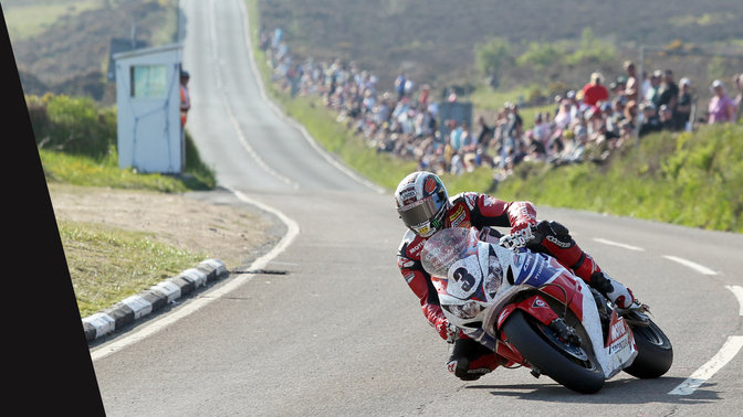 Front three quarter view of Honda CBR100RR and rider in the TT race.