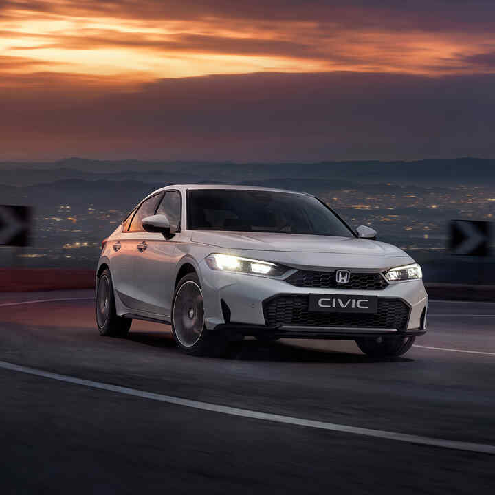 Honda Civic Hybrid v pohybe na diaľnici za súmraku.