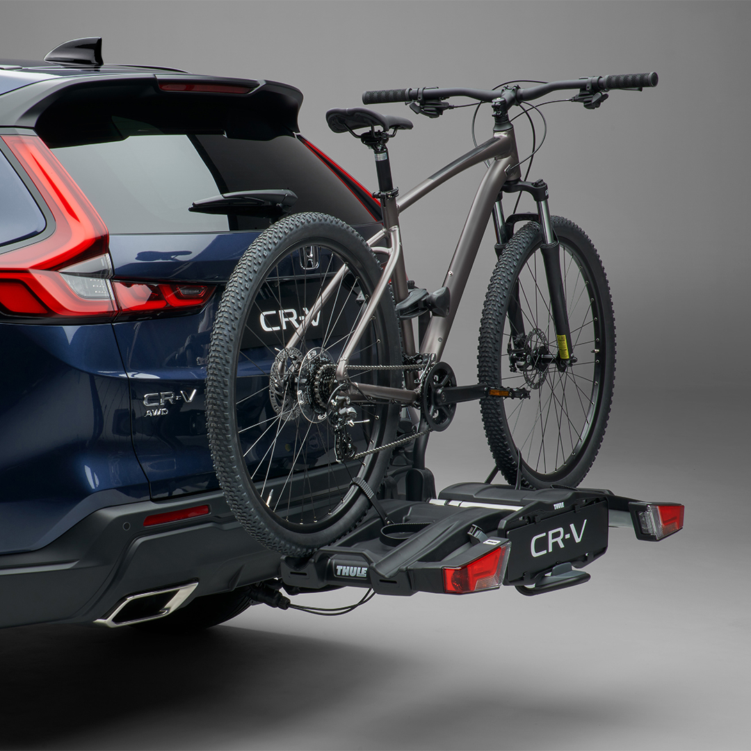 Zadný trojštvrťový pohľad na model Honda CR-V Hybrid s nosičom na bicykle.