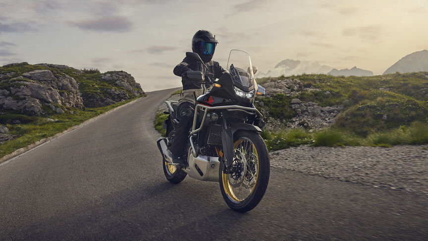 Figurant pri jazde na motocykli XL750 Transalp v lese.