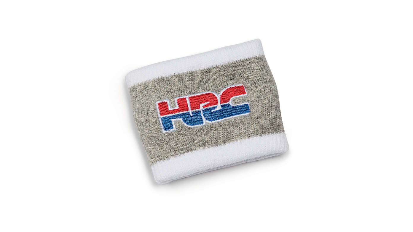 Sivá potná vložka na zápästie Honda HRC v tímových farbách HRC a s logom Honda Racing Corporation.