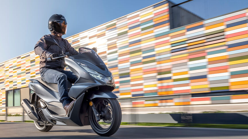 Honda PCX125 – zadný trojštvrťový dynamický záber s jazdcom