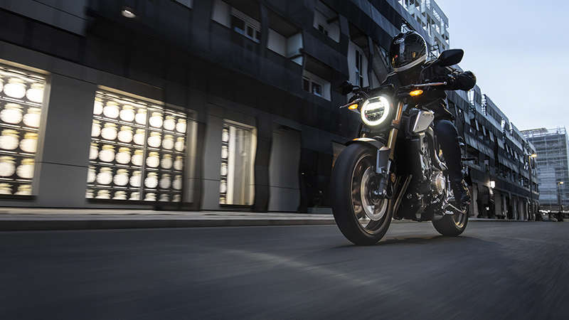 CB650R Neo Sports Café, trojštvrťový predný pohľad z ľavej strany na stroj s jazdcom v meste